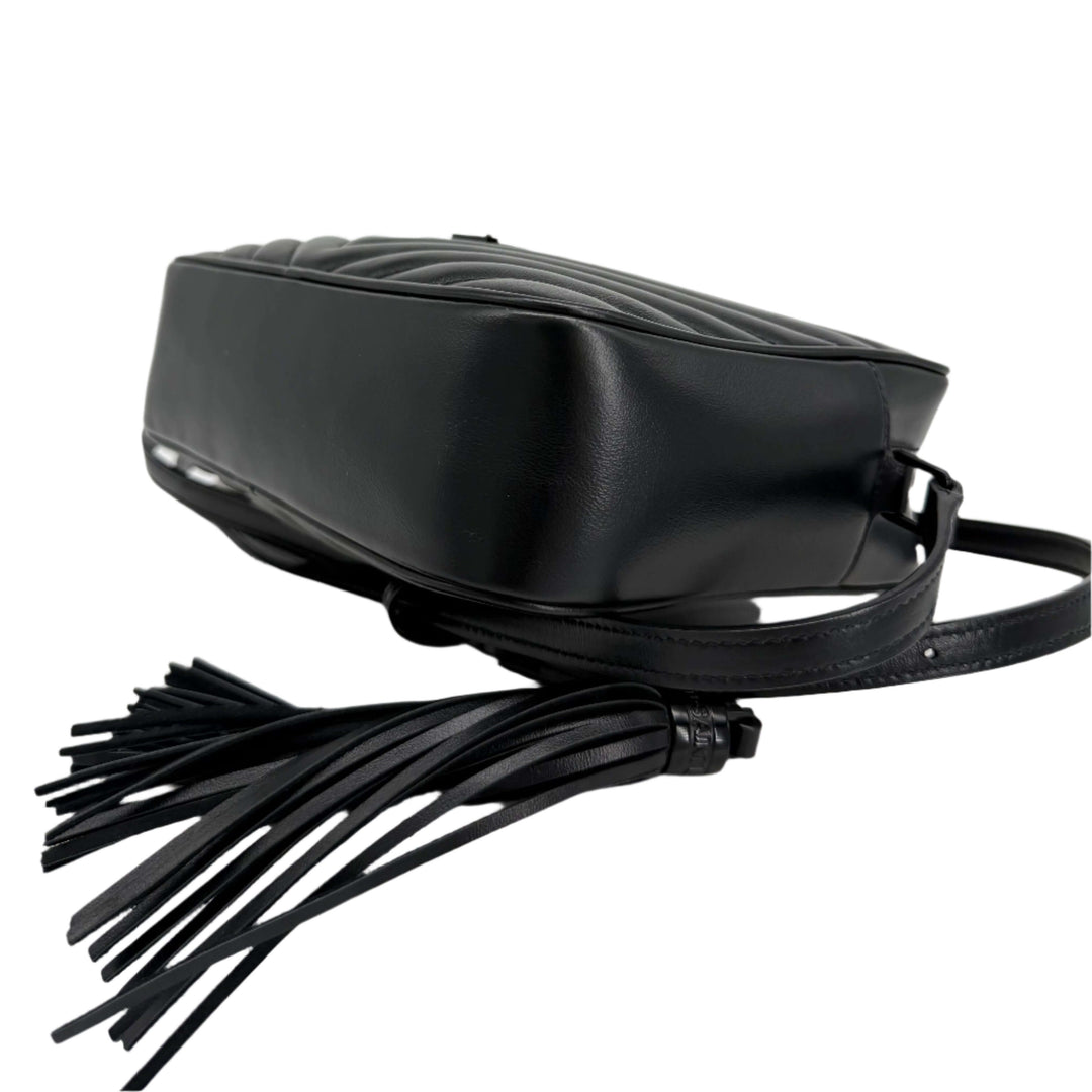 Side view of the black Saint Laurent Calfskin Matelassé Lou Camera Bag with tassel detail.