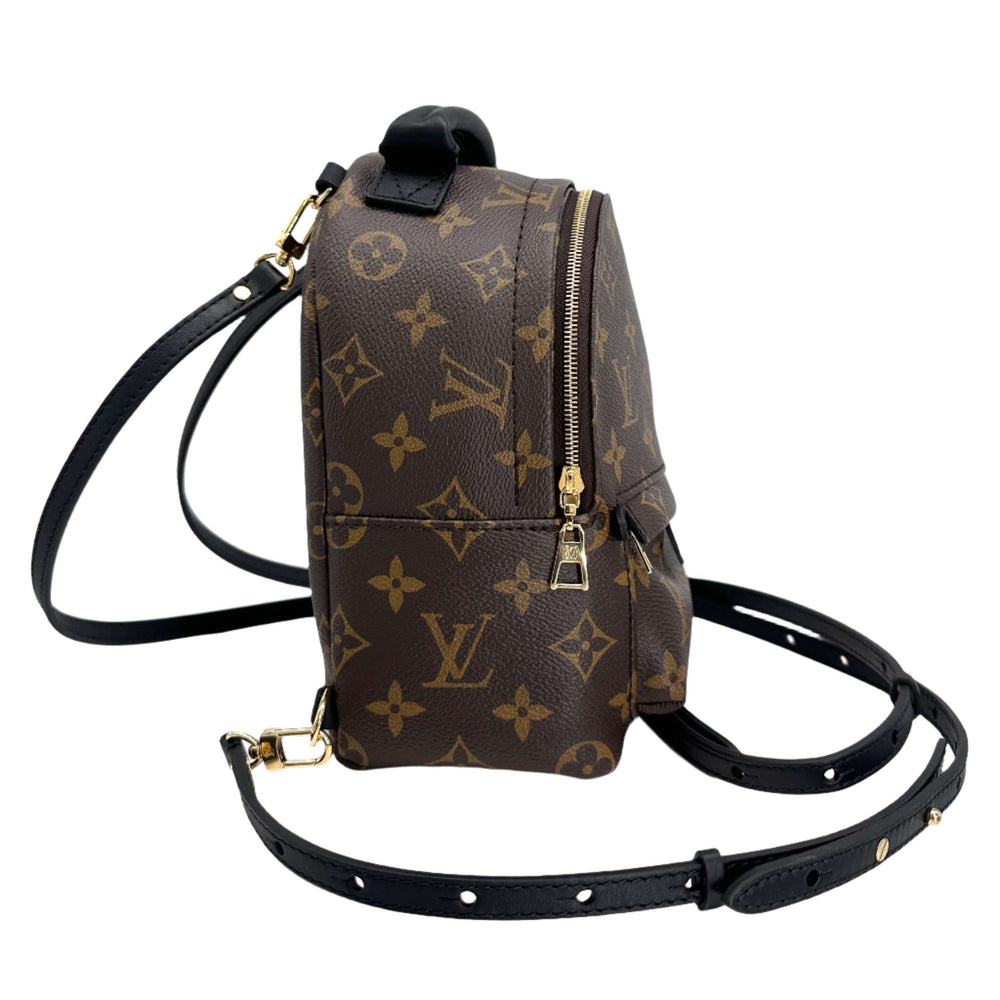 Side view of Authentic LOUIS VUITTON Monogram Palm Springs Backpack Mini with iconic monogram canvas and adjustable black leather straps.