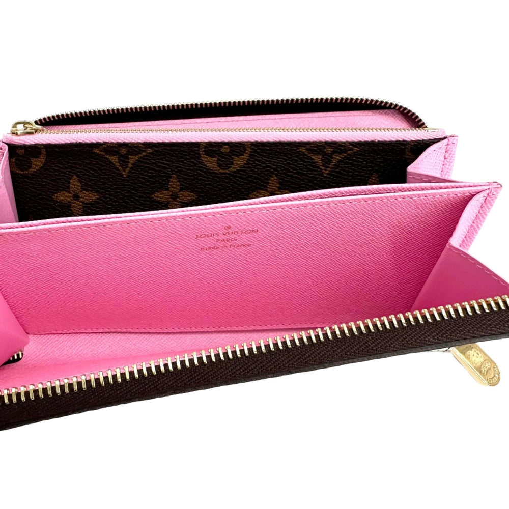 Authentic Louis Vuitton Monogram 2022 Christmas Animation Paris Zippy Wallet in Pink with signature LV monogram and vibrant pink interior.