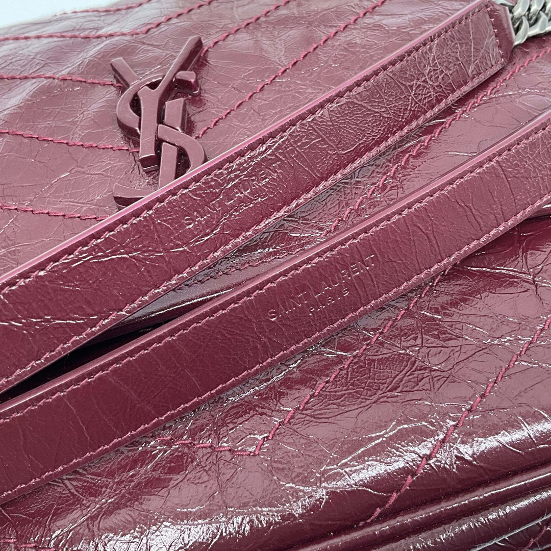 SAINT LAURENT Crinkled Calfskin Monogram Niki Chain Satchel in Rouge Legion showing textured leather and iconic YSL logo.