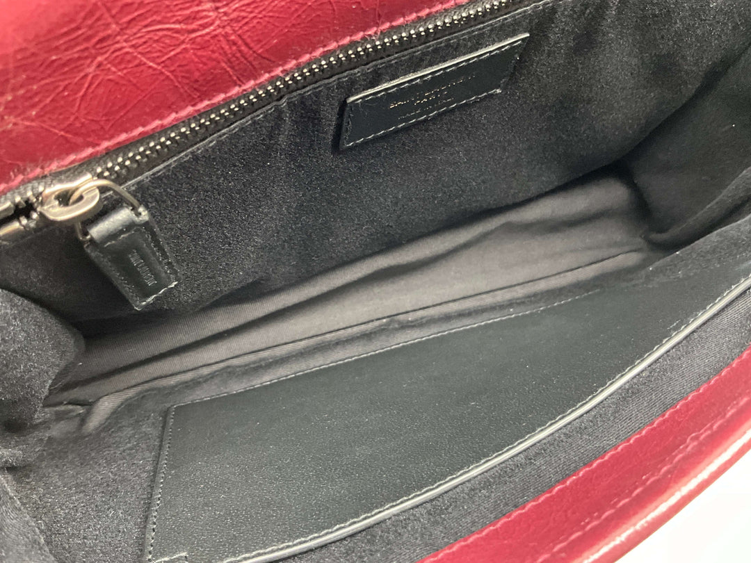 Interior view of Saint Laurent Crinkled Calfskin Monogram Niki Chain Satchel in Rouge Legion showing zip pocket and lining.