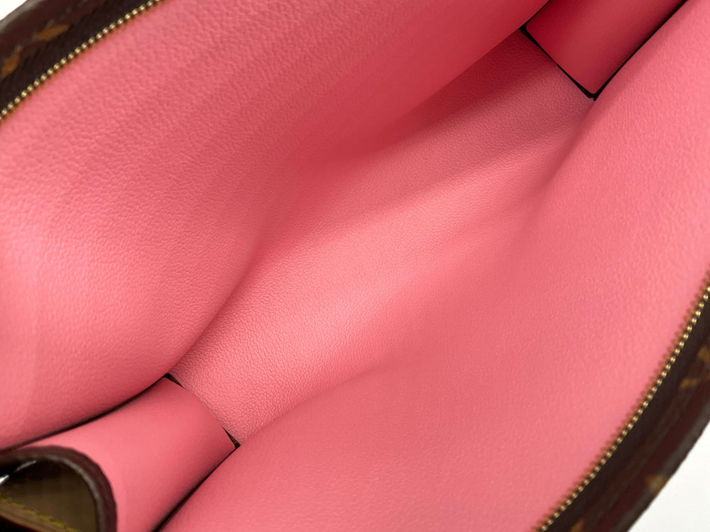 Inside view of Louis Vuitton Monogram Trio Large Toilet Pouch 26 showcasing pink leather lining and spacious interior.