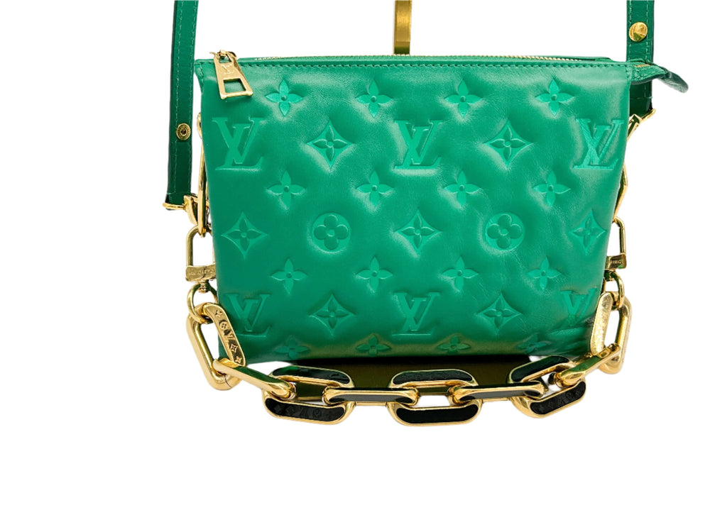 Green embossed leather pochette with gold chain strap featuring Louis Vuitton signature monogram pattern.