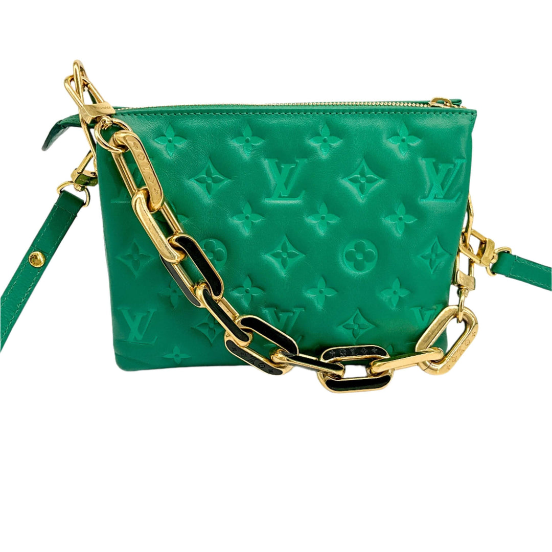 Green Louis Vuitton pochette with embossed monogram and gold chain detailing