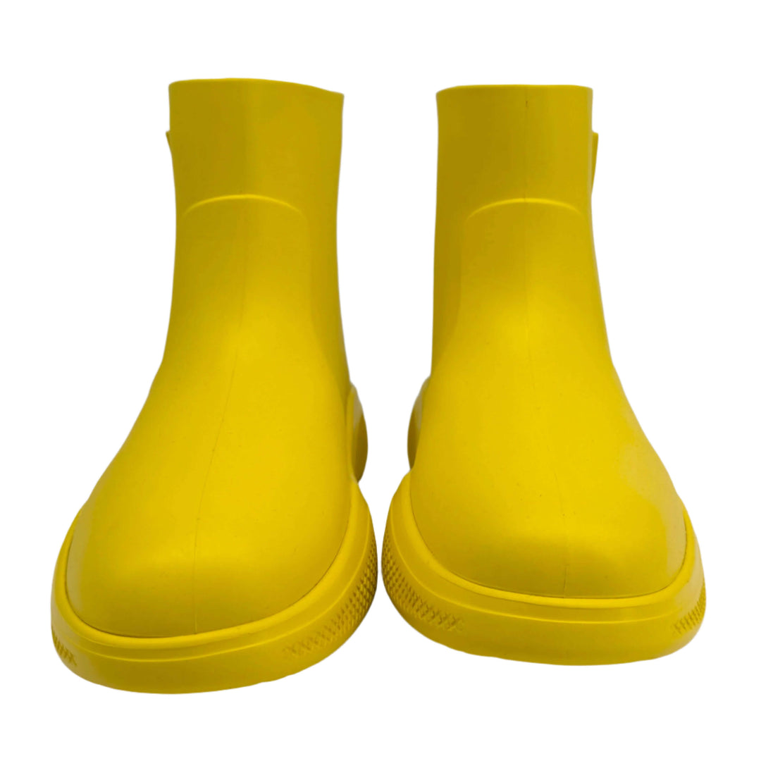 Authentic pre-owned Prada yellow rubber rain boots, size 35, showcasing vibrant yellow color and sleek design.