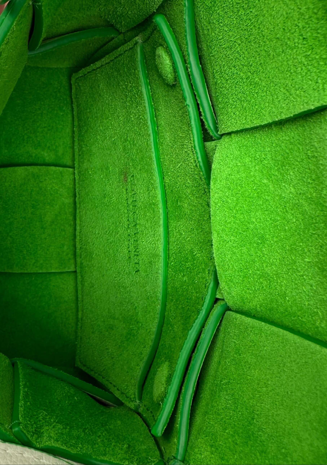 Interior view of Bottega Veneta Maxi Intrecciato Extra Mini Cassette Crossbody in vibrant green suede.