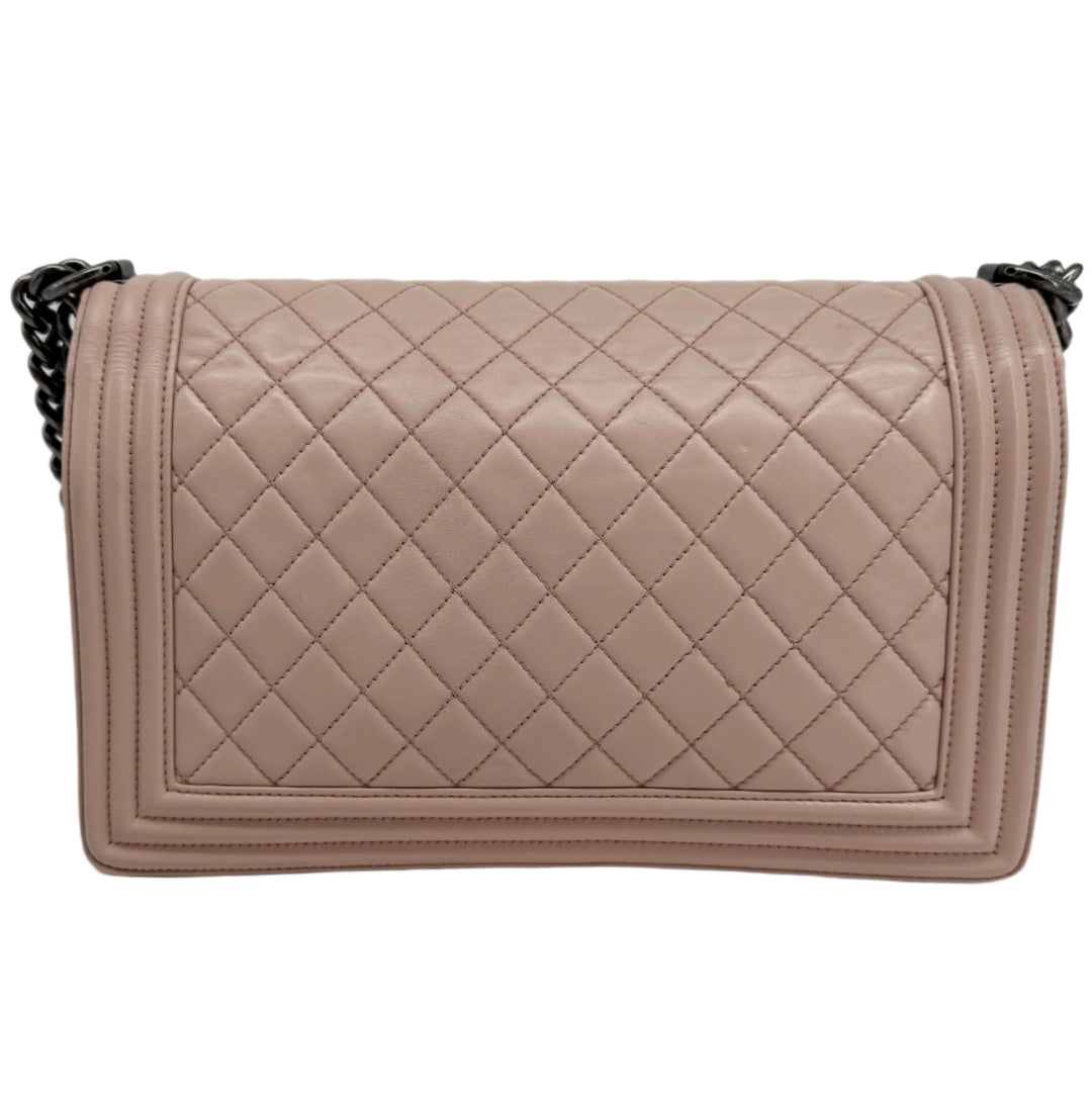 Chanel Lambskin Quilted Medium Boy Flap handbag in light pink with diamond quilt pattern and chain strap.