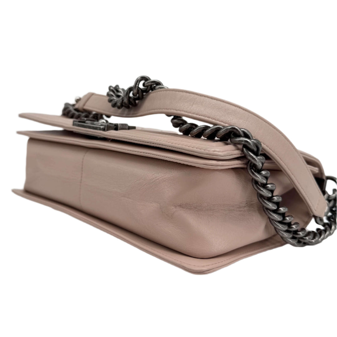 Chanel Lambskin Quilted Medium Boy Flap in Light Pink showing the side view with a ruthenium chain strap.