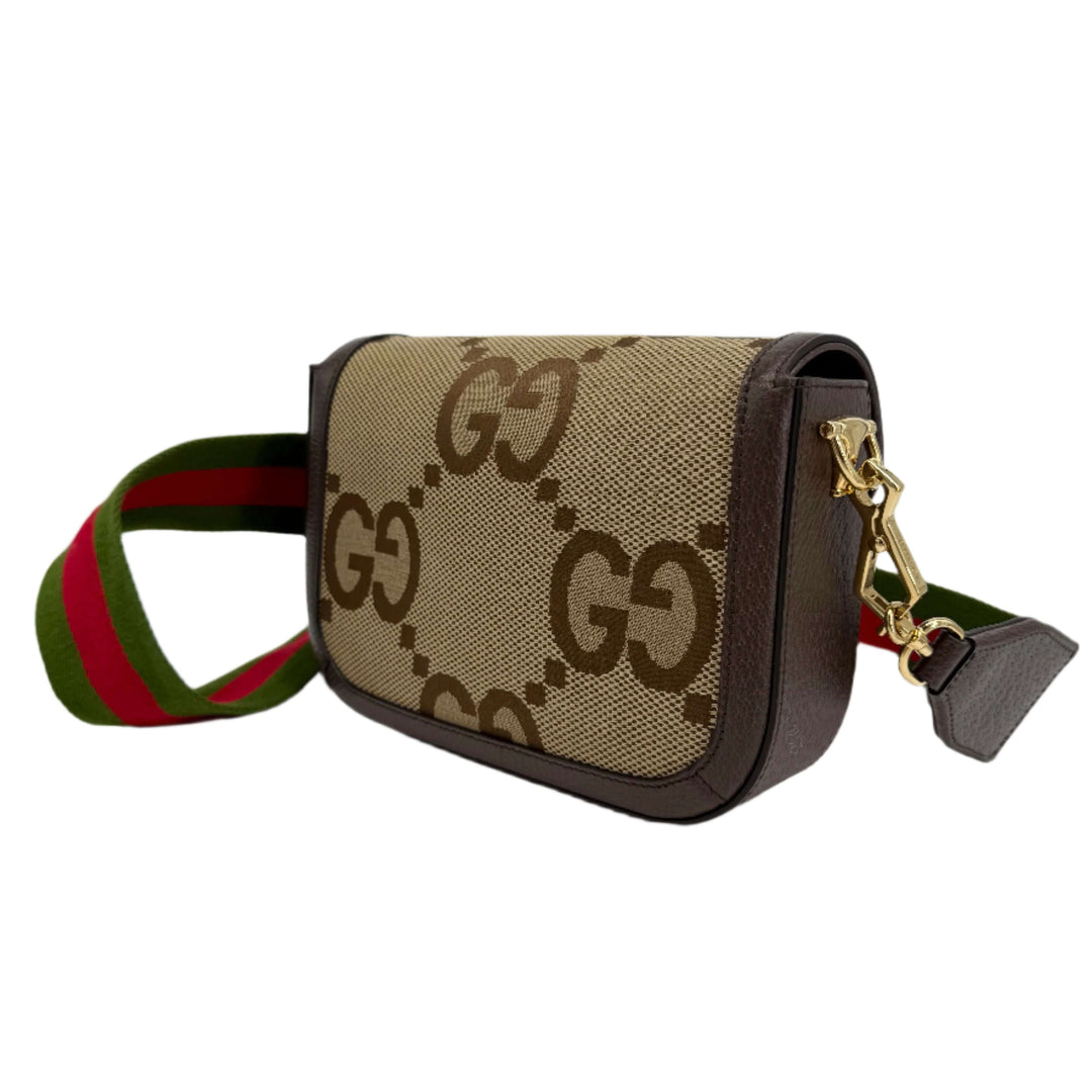 Gucci Monogram Jumbo GG Web Mini Horsebit 1955 Shoulder Bag in beige with iconic GG pattern and striped shoulder strap.