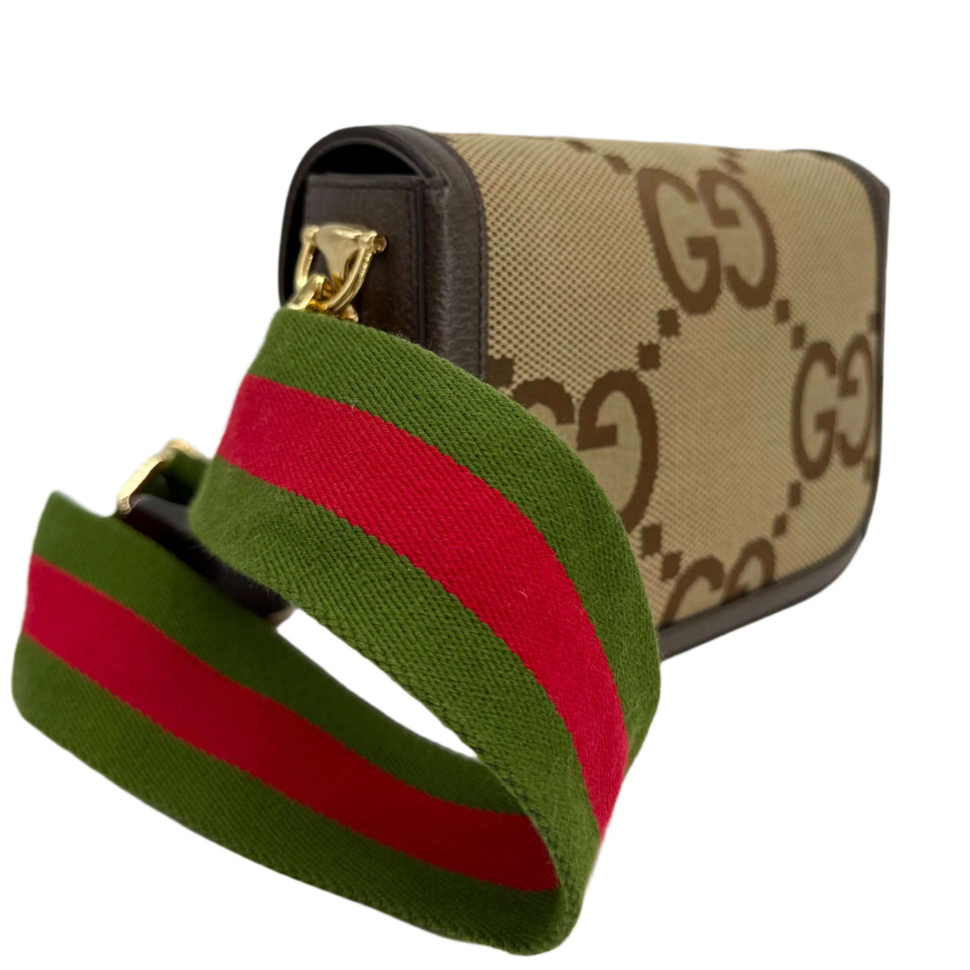 Gucci Monogram Jumbo GG Web Mini Horsebit 1955 Shoulder Bag with green and red striped strap, displaying iconic GG pattern.