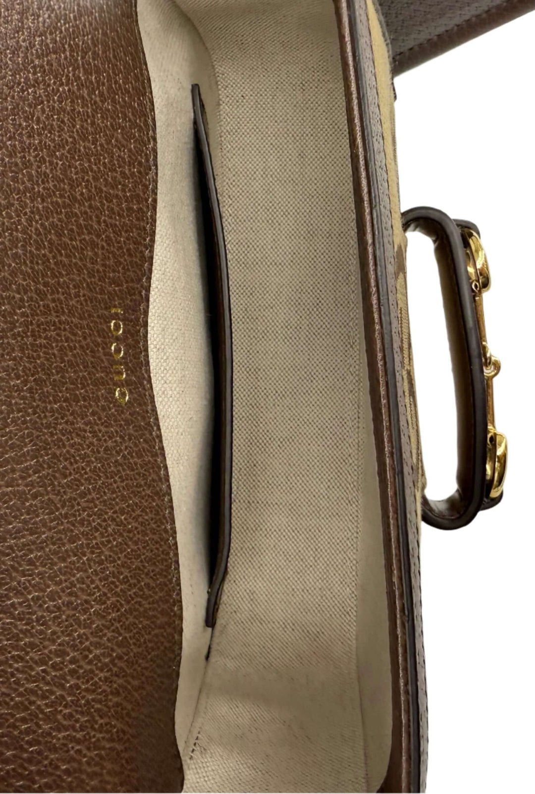 Interior view of Gucci Monogram Jumbo GG Web Mini Horsebit 1955 Shoulder Bag showing spacious compartment and logo detail.