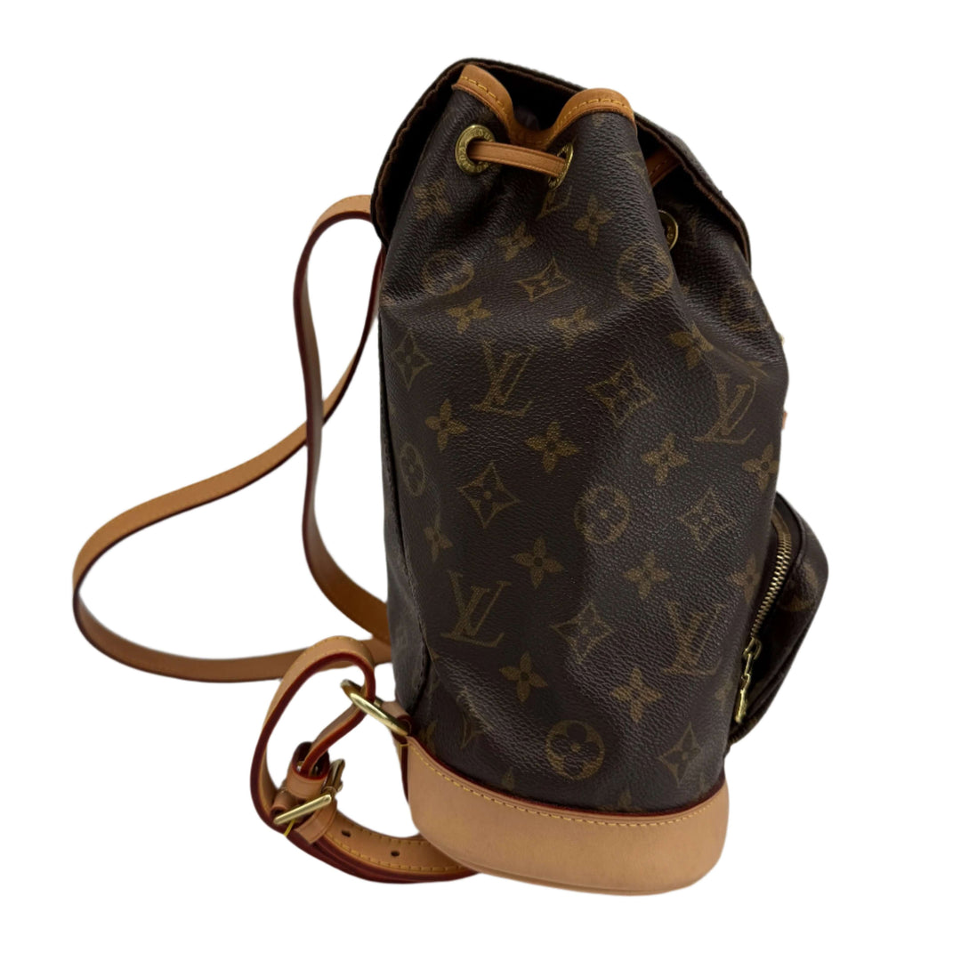 Side view of Louis Vuitton Montsouris Backpack MM in Monogram Canvas featuring vachetta leather trim.