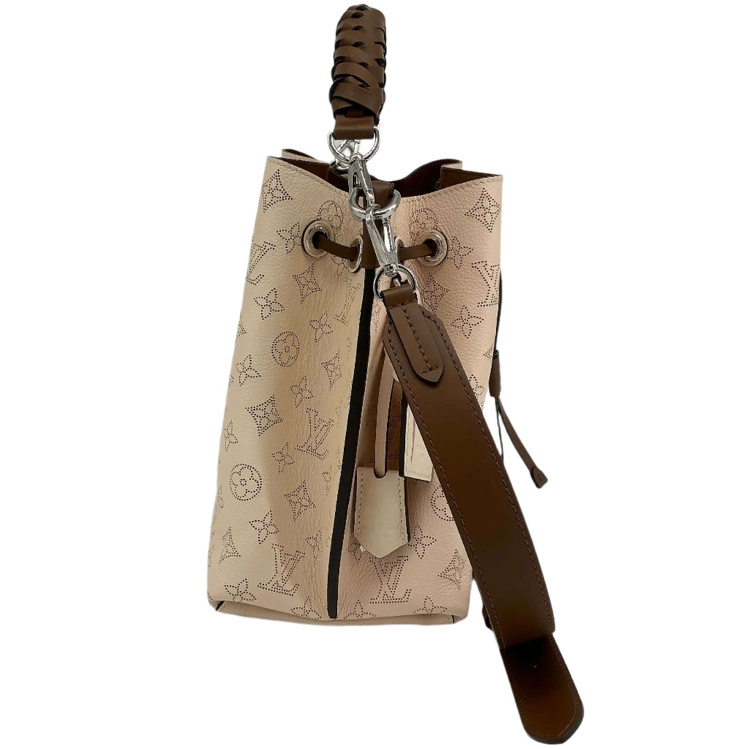 Louis Vuitton Mahina Muria handbag in Crème with braided handle and unique perforated leather design.