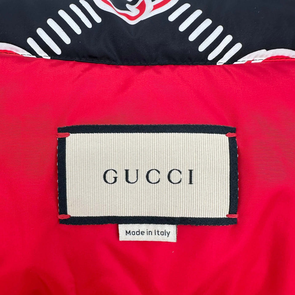 GUCCI label on red heavy puffer vest showing "Made in Italy"<|vq_12690|>