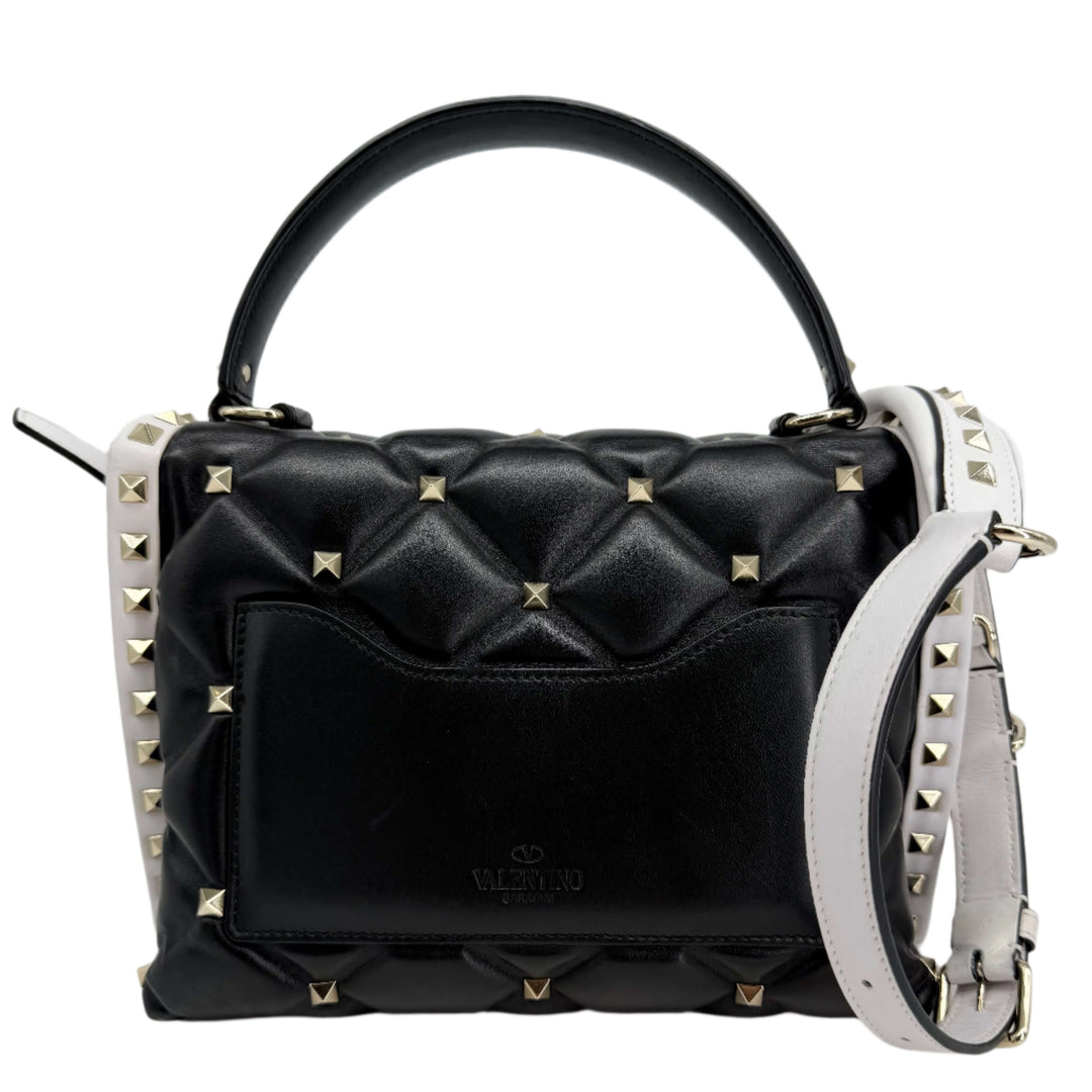 Valentino Garavani Nappa Medium Candystud Top Handle Bag in black and white with diamond quilting and studded accents.