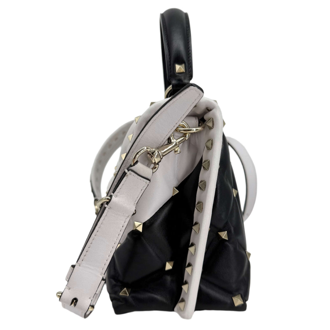 Valentino Garavani Nappa Medium Candystud Top Handle Bag in White and Black, showcasing diamond-quilted design and studs.