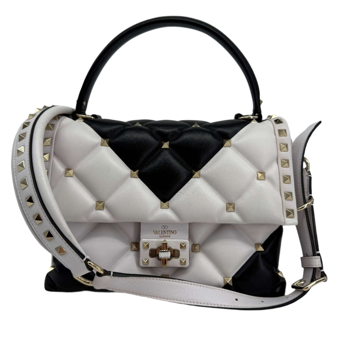 Valentino Garavani Nappa Medium Candystud Top Handle Bag in white and black with diamond quilting and gold studs.