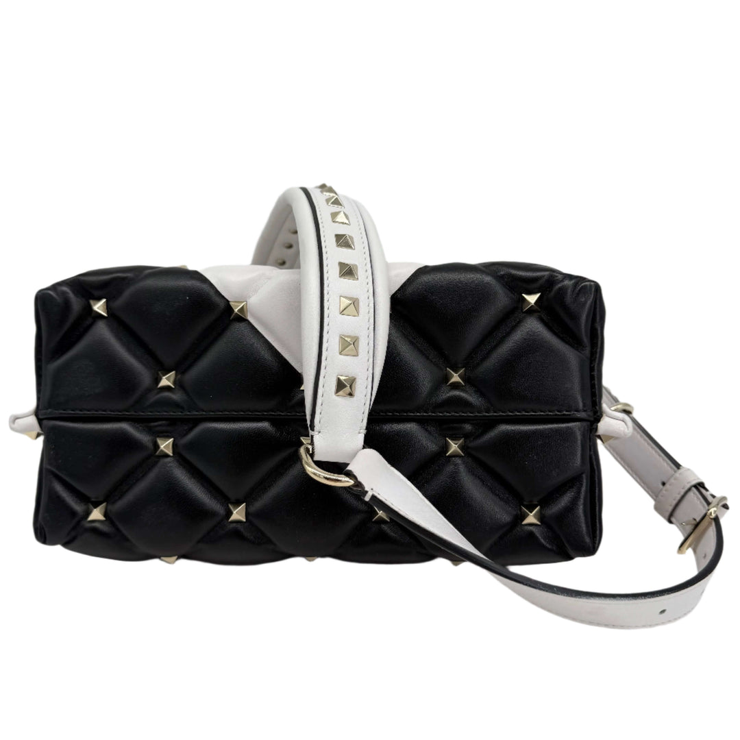 Valentino Garavani Nappa Medium Candystud Top Handle Bag in black and white, featuring diamond-quilted design and studs.