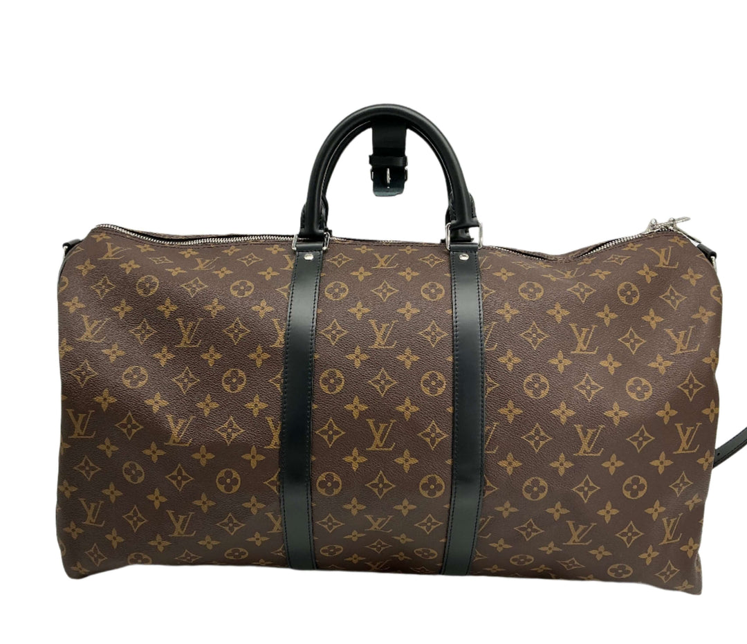 Louis Vuitton Monogram Macassar Keepall Bandoulière 55 bag with black leather trim and signature monogram canvas pattern.