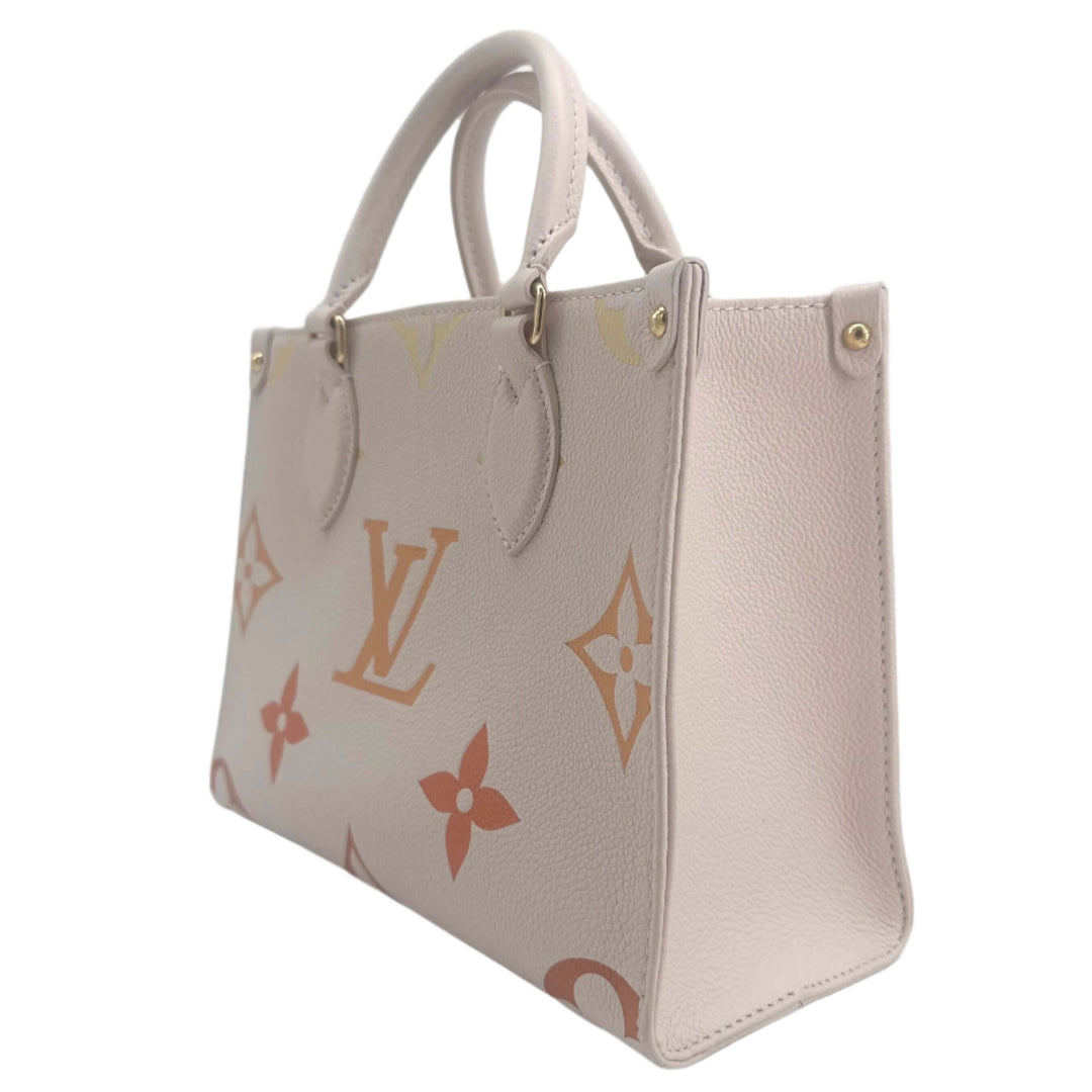 Louis Vuitton Empreinte Monogram Giant Onthego PM handbag in beige, featuring iconic logo and floral motifs, side view.