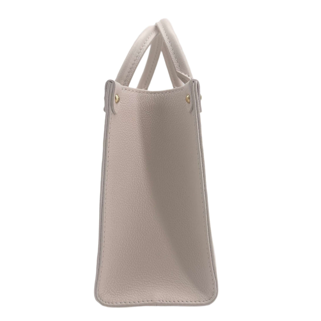 Side view of LOUIS VUITTON Empreinte Monogram Giant By The Pool Onthego PM bag in light beige, showcasing its textured leather and sleek design.