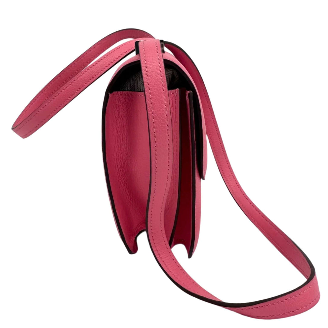 Side view of pink HERMES Epsom Constance 24 shoulder bag with adjustable strap and elegant design.