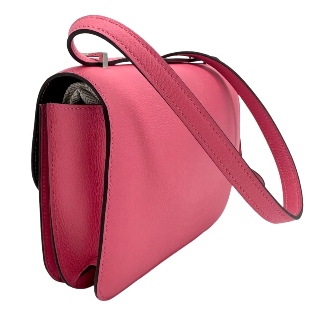 Pink HERMES Epsom Constance 24 Shoulder Bag with long strap, side view displaying fine leather texture and elegant design.