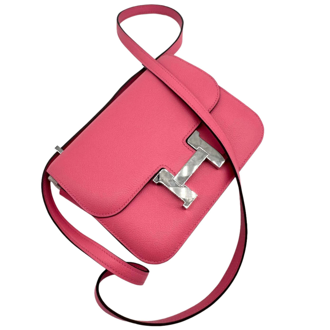 Pink HERMES Epsom Constance 24 shoulder bag with iconic silver H buckle and adjustable strap.