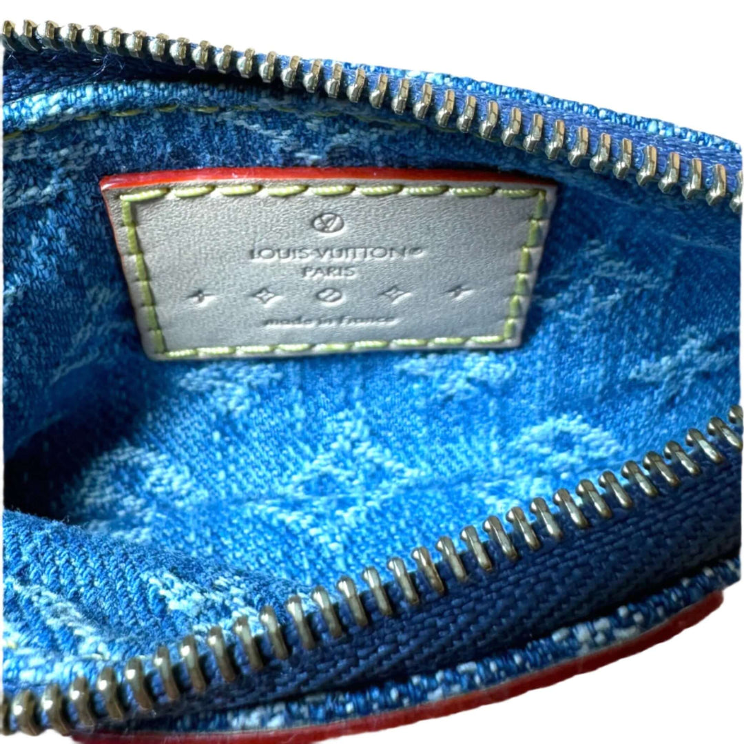 Interior view of Louis Vuitton Monogram Denim Key Pouch showcasing the signature label and vibrant blue fabric.