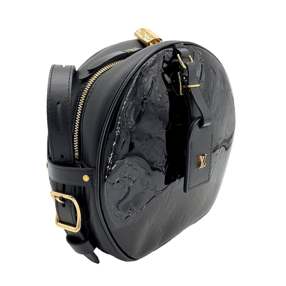 Louis Vuitton Vernis Petite Boite Chapeau Souple in glossy black with gold hardware and embossed monogram detailing, side view.