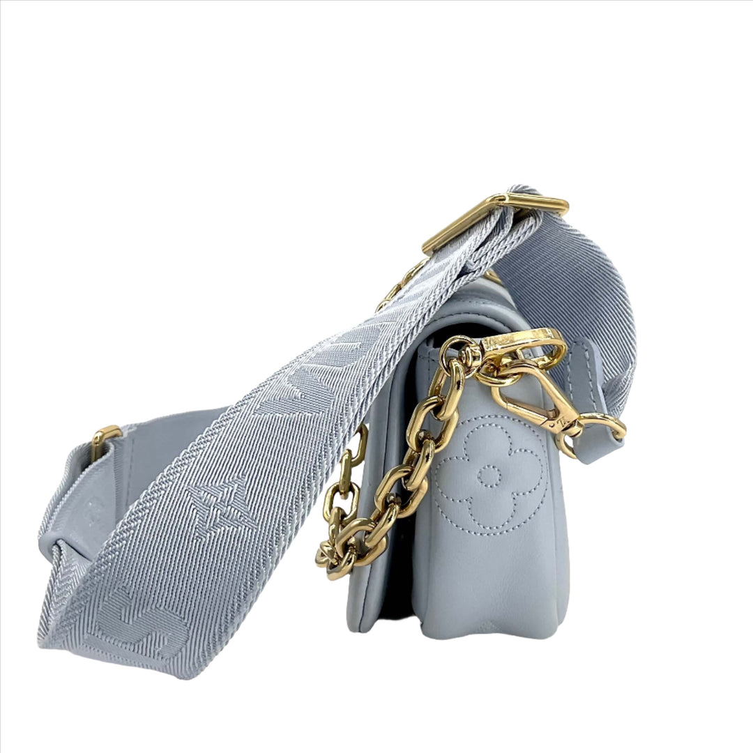 LOUIS VUITTON Calfskin Bubblegram Wallet On Strap in Ice Blue with gold-tone chain detail.