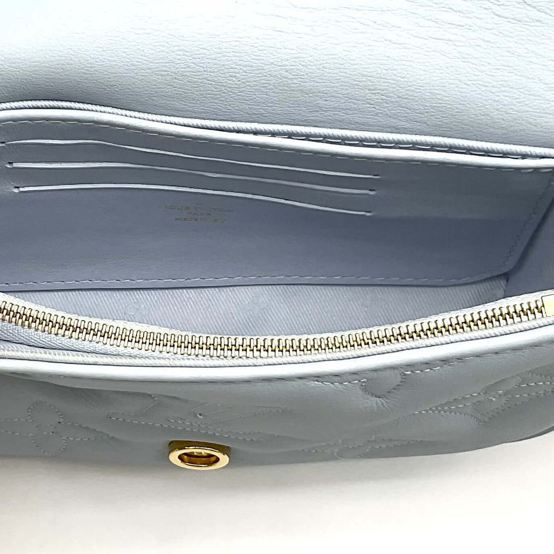 Interior of LOUIS VUITTON Calfskin Bubblegram Wallet On Strap in Ice Blue showing card slots and zipper compartment