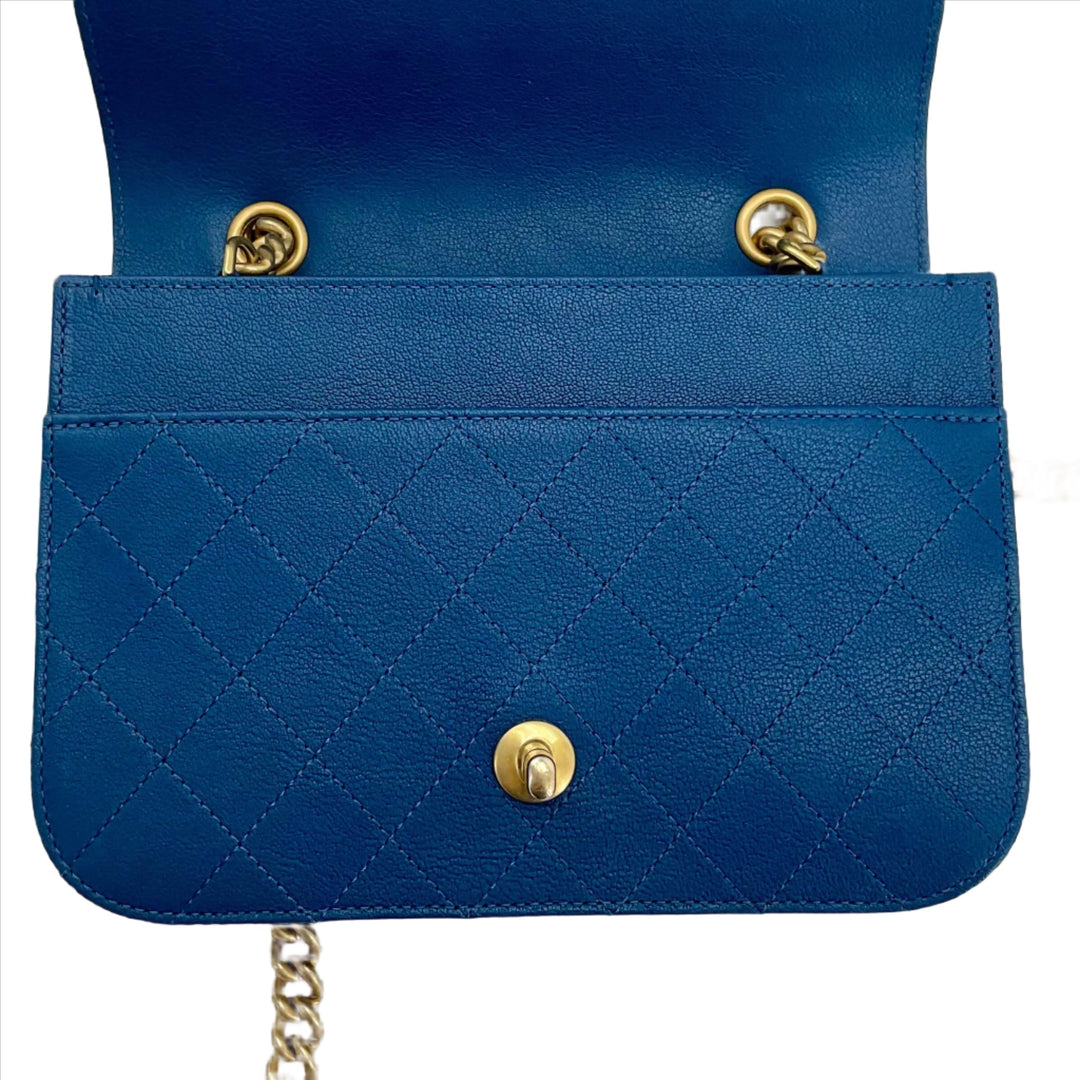 Chanel Mini Chain Front Classic Single Flap Bag in blue with quilted pattern and gold hardware, interior view with flap open