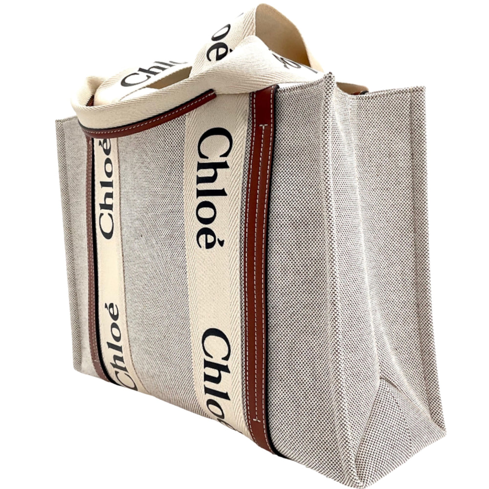 Front and side view of Chloe Medium Woody Tote Bag with beige fabric and contrasting 'Chloe' text on cream straps.