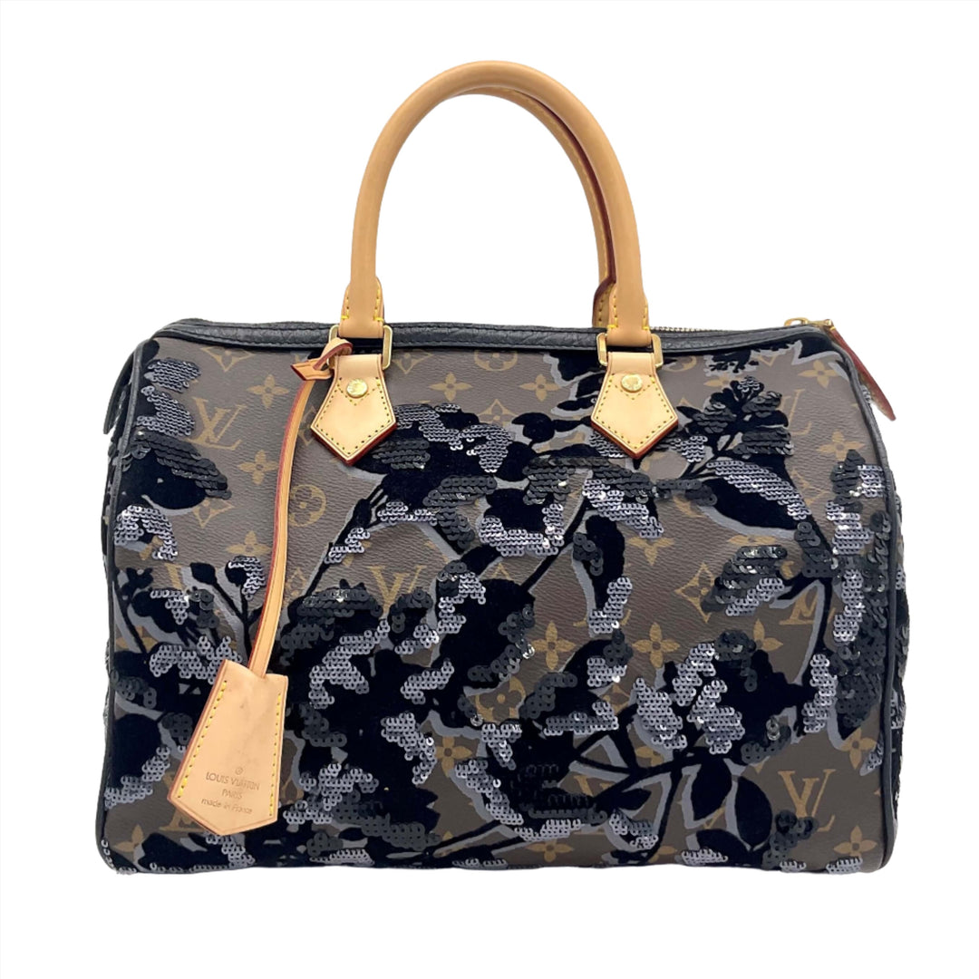 LOUIS VUITTON Speedy 30 bag in Monogram Fleur De Jais Sequins with leather handles and floral design.